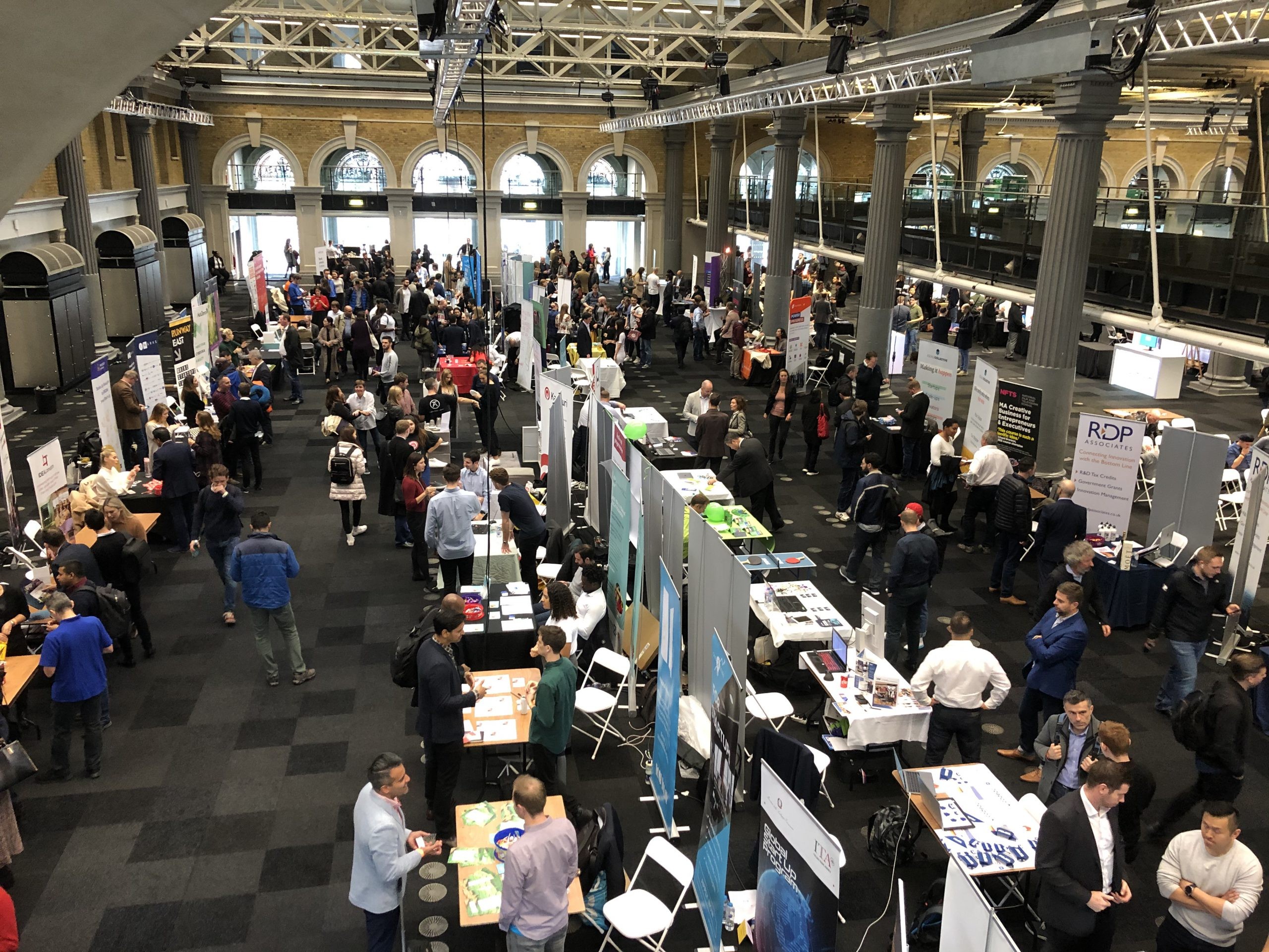 Birds eye view of 100s of stands in a conference hall at London tech